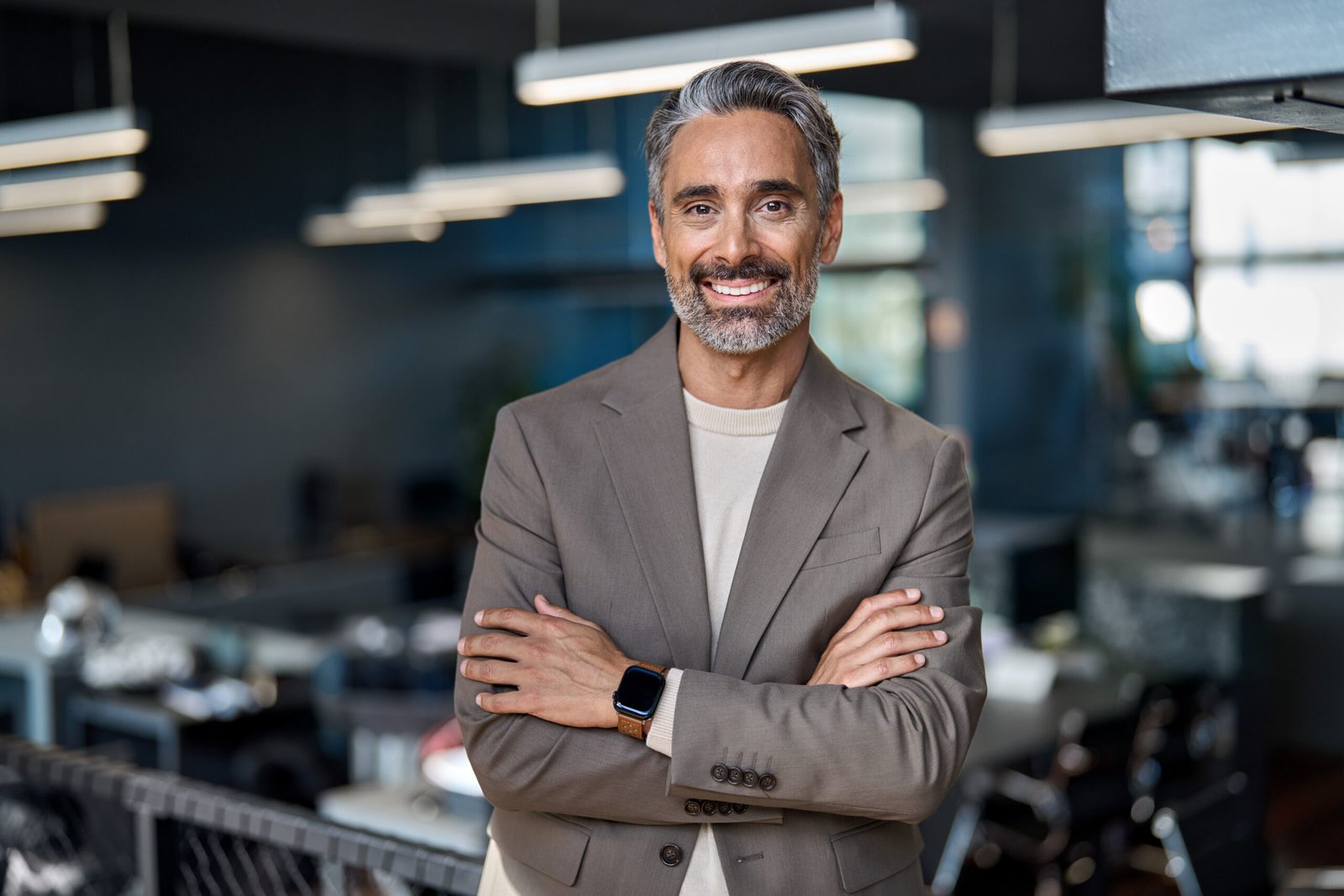 Smiling middle aged ceo business man looking at camera, portrait. Confident happy mature older professional businessman executive manager, successful lawyer in suit standing arms crossed in office.