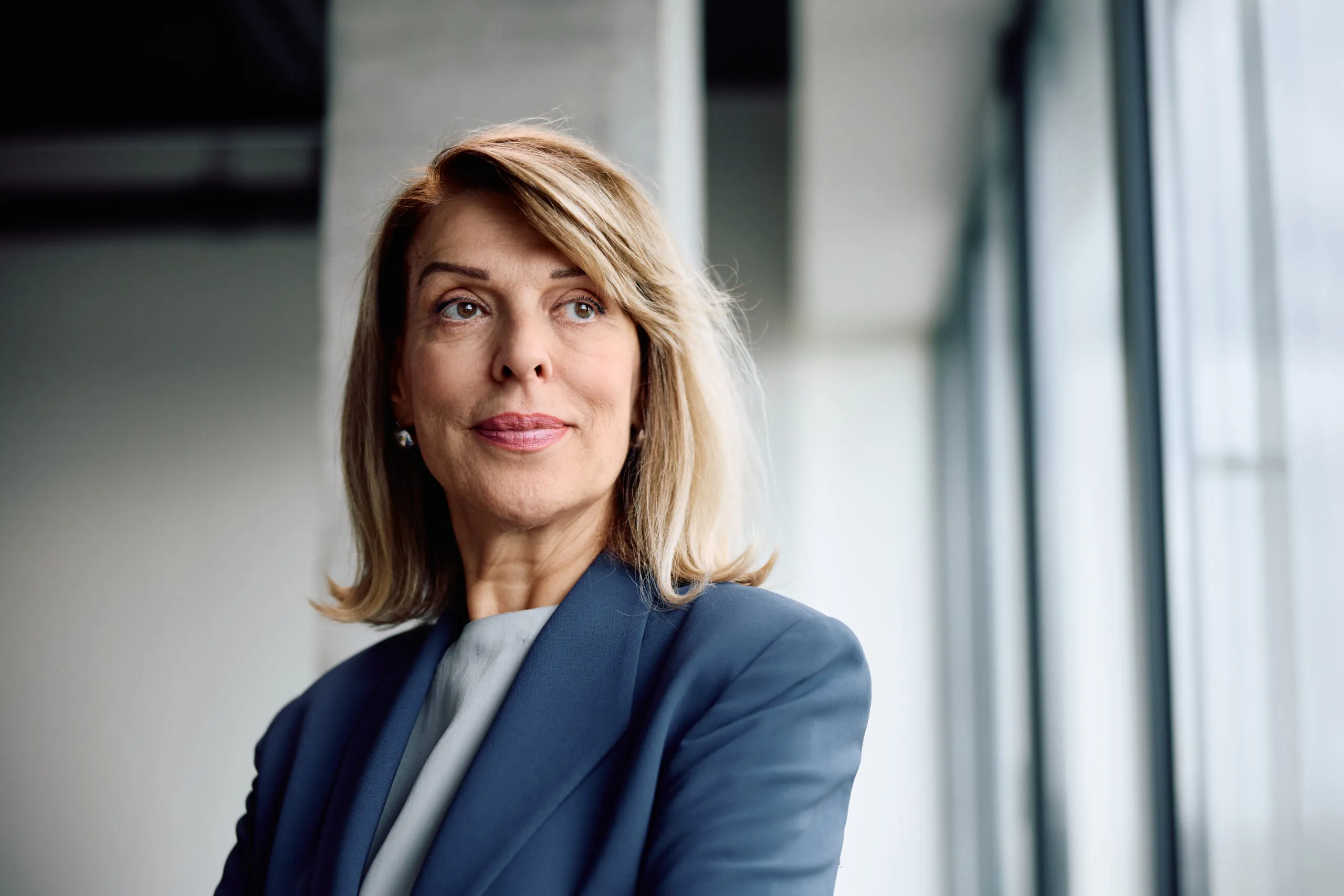 Portrait of mature businesswoman at corporate office looking away. Copy space.